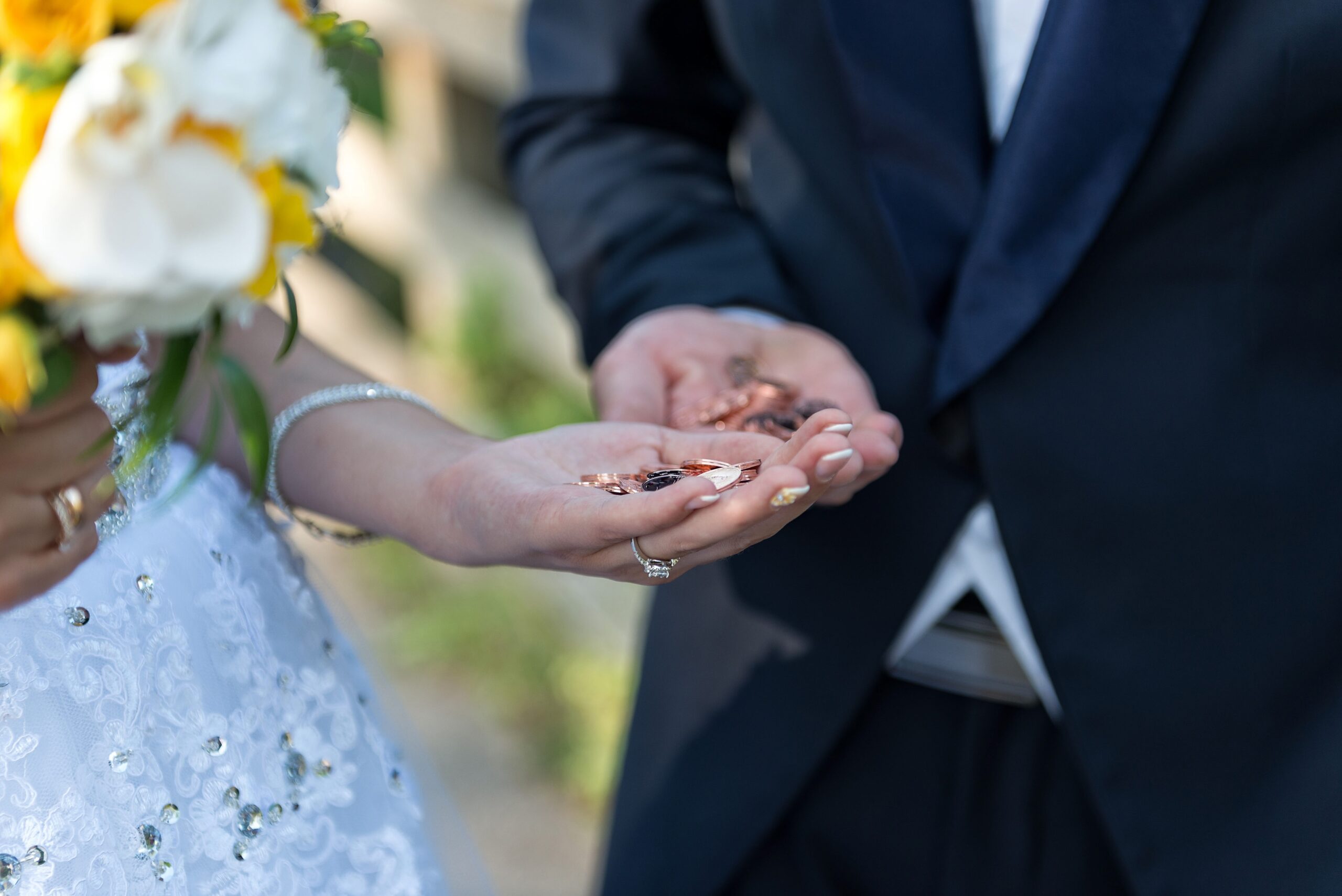 The bride and groom there with a handful of coins.
